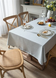Close-up of light grey faux linen tablecloth showing modern minimalist woven texture