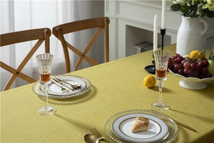 Close-up of mustard yellow tablecloth showing premium woven linen texture and drape
