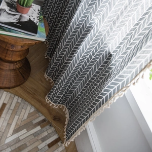 Grey herringbone pattern cotton-polyester curtain with delicate cream fringe tassels