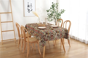 Detail of colorful geometric Bohemian tablecloth with rustic texture in a warm home dining setting