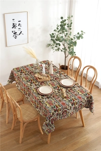 Detailed texture of bohemian geometric pattern tablecloth on a wooden dining table