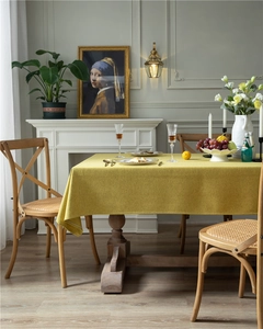Close-up of thick yellow linen-textured tablecloth fabric with natural weave details