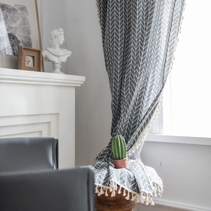 Minimalist grey poly-cotton curtains with white chevron pattern and tassel fringes