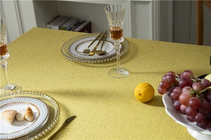 Close-up of mustard yellow thick faux linen tablecloth with rich woven texture details