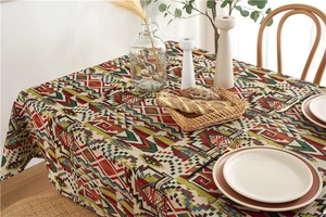 Detail of bohemian geometric tablecloth with colorful patterns on a wooden table