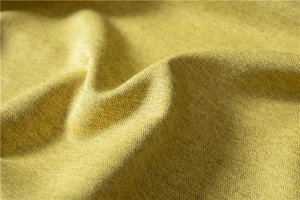 Macro detail of thick mustard yellow mustard herringbone fabric showing dense weave texture