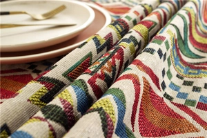 Close-up of bohemian table runner featuring dense geometric woven ethnic patterns