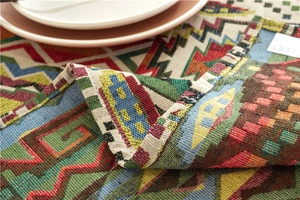 Detailed close-up of bohemian woven tablecloth showing ethnic patterns and thick fabric texture