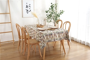Detail of bohemian polyester tablecloth with colorful feather patterns and linen texture