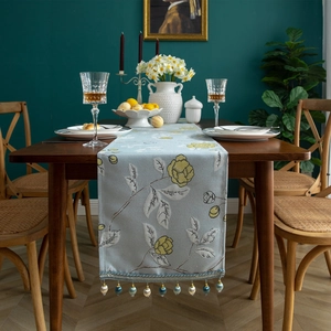 Modern light blue polyester table runner with yellow floral embroidery and beaded tassels
