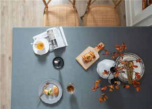 Flat lay of gray minimalist tablecloth showing fine woven texture and premium fabric drape