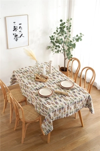 Close-up of colorful feather patterns on a beige bohemian style polyester tablecloth