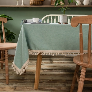 Sage green minimalist rectangular tablecloth with elegant beige lace and tassel edges