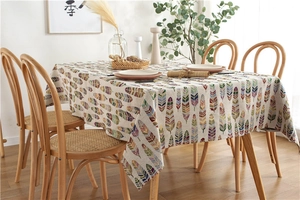 Detail of colorful feather prints on bohemian style textured rectangular tablecloth