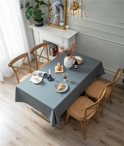 Detail shot of grey blue linen texture tablecloth with elegant draping on a dining table