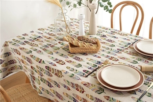 Detail of bohemian polyester tablecloth with colorful feather patterns and textured fabric