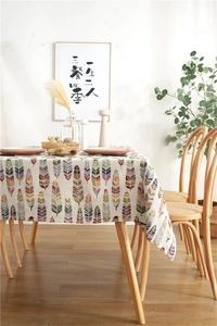 Close-up of colorful feather pattern on woven fabric tablecloth with bohemian style