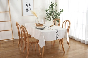 Detail of minimalist cream rectangular tablecloth featuring cursive black lettering
