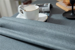 Close-up of thick dark blue linen-look tablecloth with textured herringbone weave