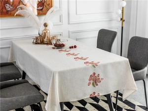 Detailed view of pink floral embroidery on natural linen rectangular tablecloth
