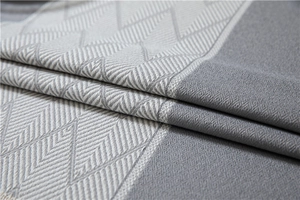 Macro detail of grey and white geometric jacquard fabric with soft fringe texture