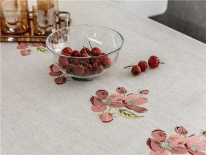 Close-up of pink flower embroidery and texture on a linen rectangular tablecloth