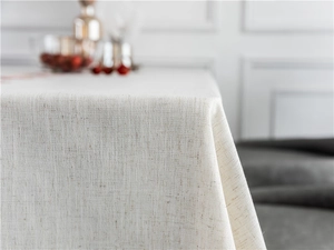 Close-up of oatmeal linen textured tablecloth showing fabric weave and elegant corner drape