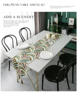 Detail view of colorful chenille table runner with leaf pattern and bead tassel fringe