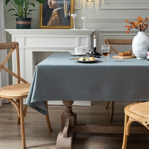 Deep grey-blue faux linen rectangular tablecloth on a wooden dining table