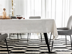 Close-up of oatmeal linen textured tablecloth with elegant draped edges on a dining table