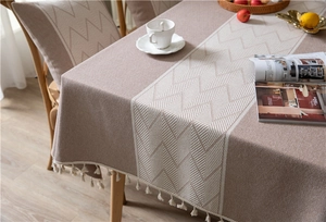 Close-up of jacquard geometric wave pattern fabric with elegant white fringe details