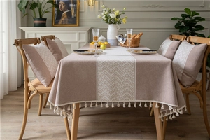 Detailed view of Morandi pink jacquard tablecloth with wave pattern and elegant cream tassels