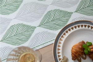 Detailed view of jacquard leaf pattern and edge stitching on a chenille table runner