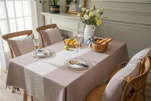 Close-up of jacquard wave pattern and elegant tassel fringe on a luxury tablecloth