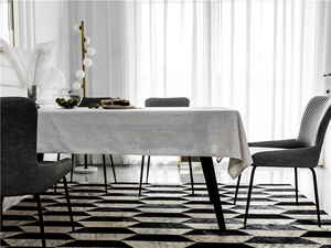 Detail of gray minimalist embroidered tablecloth with linen texture on dining table