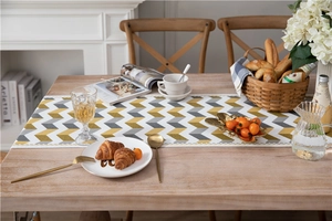 Detail of jacquard chenille table runner featuring yellow and grey chevron patterns