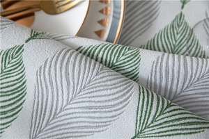 Macro detail of leaf-patterned jacquard chenille fabric with premium texture and embroidery