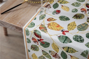 Close-up of Chenille table runner showing detailed leaf patterns and fabric texture