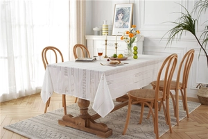 Detailed macro of white lace embroidery tablecloth with hollowed geometric patterns