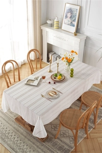 Detail of white French lace tablecloth with vertical Broderie Anglaise hollow embroidery