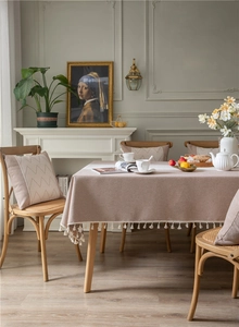 Detailed view of jacquard table cloth with delicate wave fringe and tassel lace trim