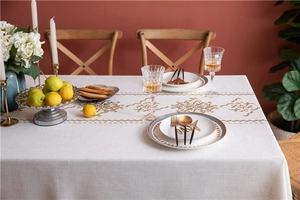 Detailed embroidery of gold flower patterns on premium cotton linen tablecloth fabric