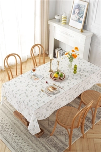 Close-up of lilac floral cotton jacquard tablecloth texture on a rustic dining table