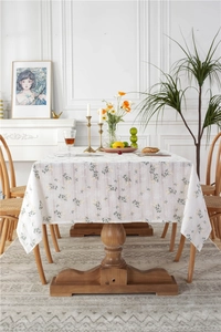 Close-up of lilac floral cotton tablecloth with green leaves and yellow flowers