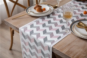 Close-up of jacquard chenille table runner with grey and pink 3D chevron patterns