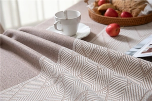 Close-up of jacquard woven tablecloth featuring white geometric patterns and textures