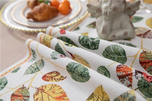Macro detail of chenille table runner with autumn leaf pattern and woven texture