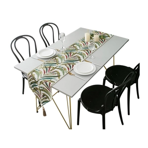 Modern white table runner with colorful tropical leaf prints and decorative tassels