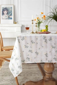 Detail of floral jacquard cotton tablecloth showing yellow blossoms and fabric texture