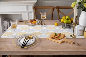 Detailed texture of chenille table runner with yellow and grey leaf jacquard weave
